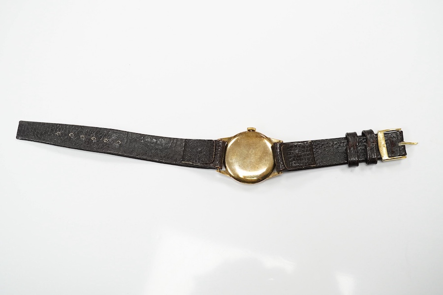 A gentleman's late 1930's 9ct gold Movado manual wind wrist watch, with baton and quarterly numerals and subsidiary seconds, case diameter 29mm, on an associated leather strap. Condition - fair